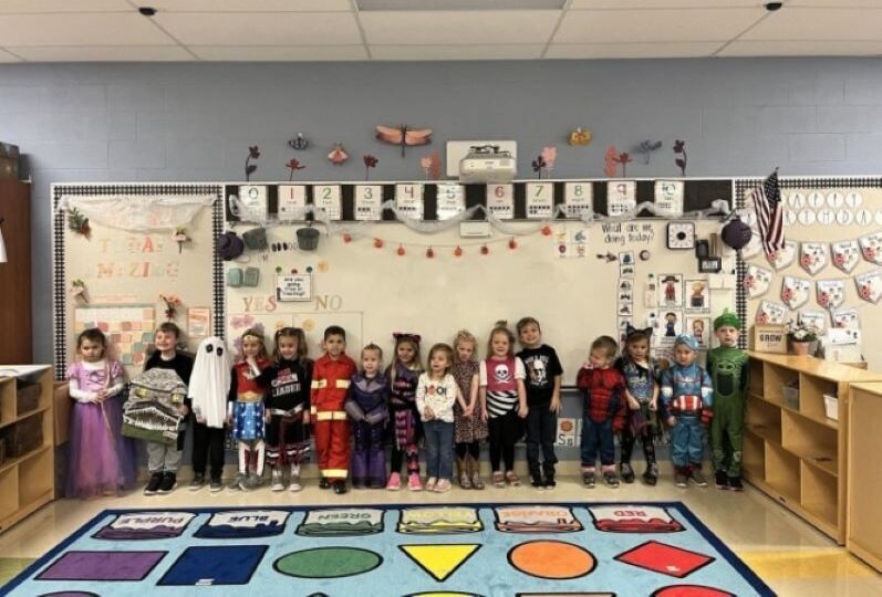 Group of kids in costumes in classroom
